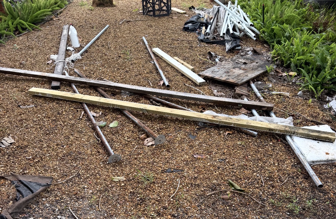 Before and after junk removal: construction debris and landscape fabric cleared from a gravel path by All Out Rubbish (before)